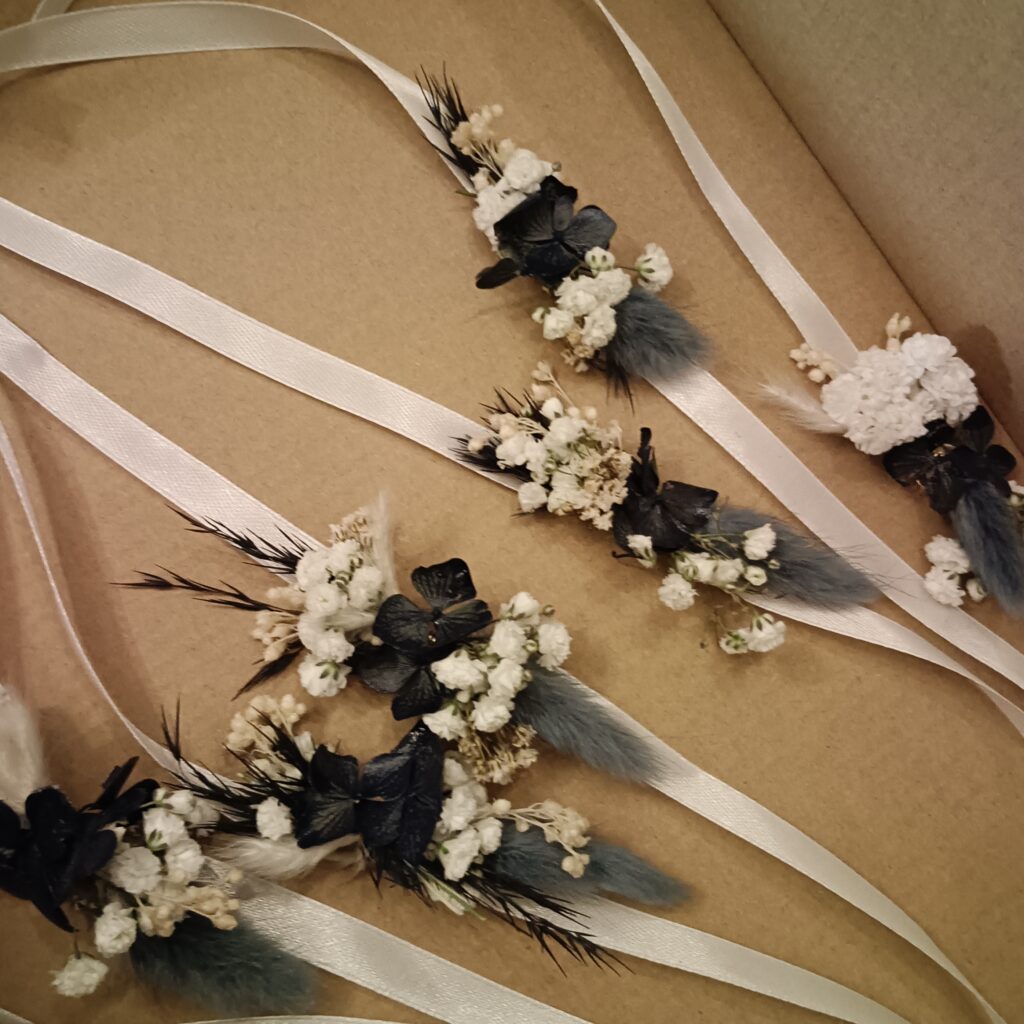 Blumenarmbänder in Creme und Schwarz – Hochzeitsschmuck Vöcklabruck